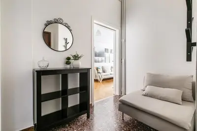 a living room with a couch and a mirror at Serenity - 1-BR Apartment in Zografou in Athens
