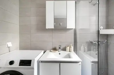 a bathroom with a sink and a washing machine at Serenity - 1-BR Apartment in Zografou in Athens