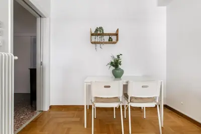 a white dining room with a white table and white chairs at Serenity - 1-BR Apartment in Zografou in Athens