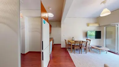 a kitchen and dining room with a table and chairs at Prigipos Petrou Cozy Apartment Glyfada in Athens