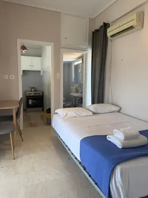 a bedroom with a bed and a table in it at Beautiful apartment in Petralona in Mesochórion