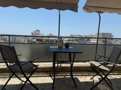 a table and chairs on a balcony with a view at Beautiful apartment in Petralona in Mesochórion