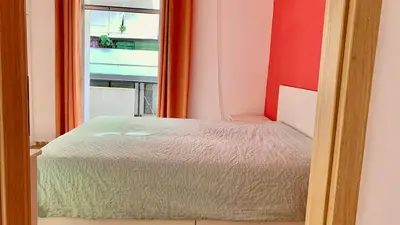 a small bed in a room with a window at 1bedroom 300 meter Dafni metro in Athens