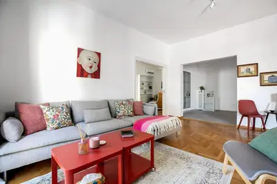 a living room with a couch and a table at Artsi - Vibrant 3-BR Apartment & Balcony in Athens in Athens