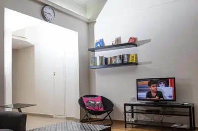 a living room with a tv on a table at Athens Charm in Athens