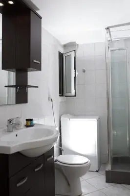 a bathroom with a toilet and a sink and a shower at Athens Charm in Athens