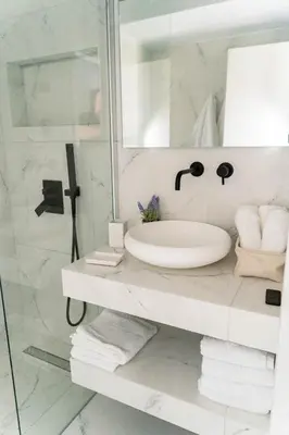 a white bathroom with a sink and a shower at One&Only apartment in Athens