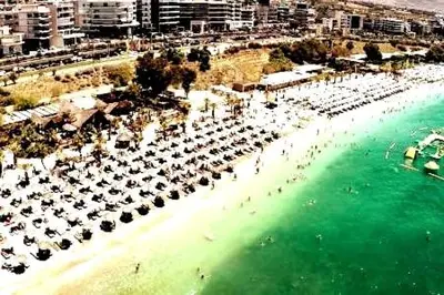an aerial view of a beach with umbrellas at Four Seasons Cozy Apartment Paleo Faliro South Ath in Athens