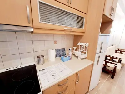 a small kitchen with a stove and a refrigerator at Iris' Home in Piraeus