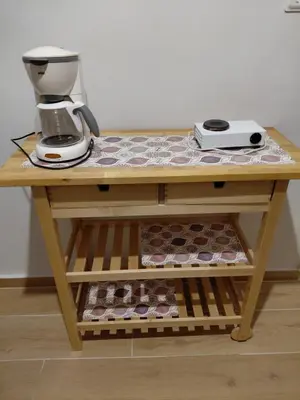 a table with a coffee maker on top of it at Iris' Home in Piraeus