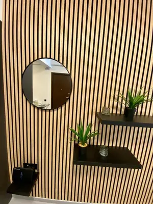 a mirror on a wall with two plants on shelves at Filolaou New Beautiful Apartment in Athens