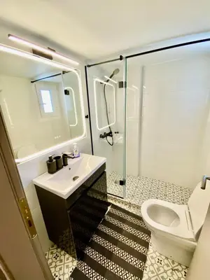 a bathroom with a toilet and a sink and a shower at Filolaou New Beautiful Apartment in Athens