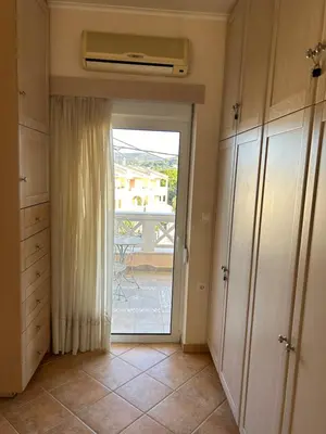a kitchen with a door leading to a balcony at Villa Clio in Porto Rafti