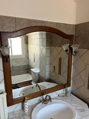 a bathroom with a tub and a sink and a mirror at Villa Clio in Porto Rafti