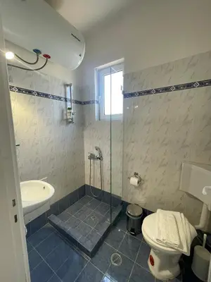 a bathroom with a shower and a toilet and a sink at RunWay Stay-24h self check in- Athens Airport in Porto Rafti