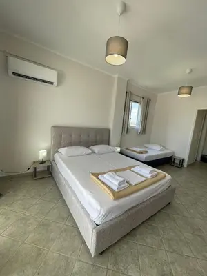 a bedroom with a large bed with towels on it at RunWay Stay-24h self check in- Athens Airport in Porto Rafti