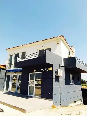 a black and white house with a balcony at RunWay Stay-24h self check in- Athens Airport in Porto Rafti