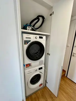 a washer and dryer in a small closet at Niarchos Park View Maisonette in Athens