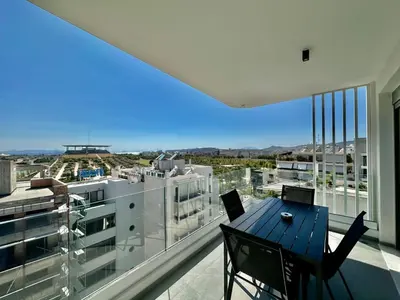 a balcony with a table and chairs and a large window at Niarchos Park View Maisonette in Athens