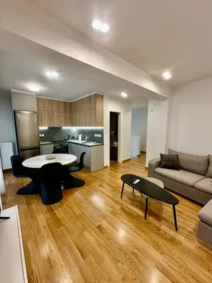 a living room with a table and a couch at Niarchos Park View Maisonette in Athens