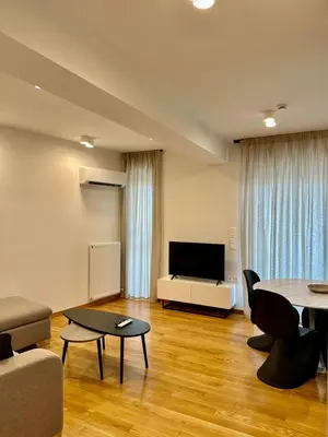 a living room with a couch and a table at Niarchos Park View Maisonette in Athens