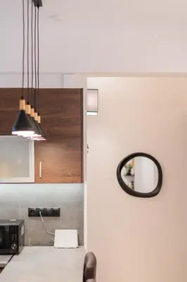 a kitchen with a table with a mirror and a microwave at The Athenian Spot in Athens