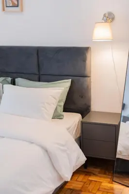 a bedroom with a white bed and a lamp at The Athenian Spot in Athens