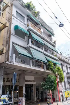 a building with balconies on the side of it at The Athenian Spot in Athens