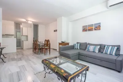 a living room with a couch and a table at Acropolis Monastiraki Psiri Central Apartment in Athens