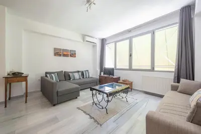 a living room with a couch and a table at Acropolis Monastiraki Psiri Central Apartment in Athens