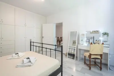 a bedroom with a bed and a desk and a chair at Acropolis Monastiraki Psiri Central Apartment in Athens