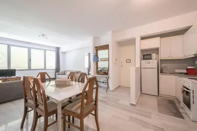 a kitchen and living room with a table and chairs at Acropolis Monastiraki Psiri Central Apartment in Athens