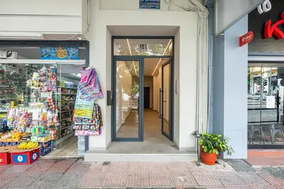 a store entrance to a store with glass doors at Rooms151 Smart Suite in the Heart of Athens 2nd floor 4B in Athens