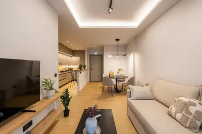a living room with a couch and a table at Rooms151 Smart Suite in the Heart of Athens 2nd floor 4B in Athens