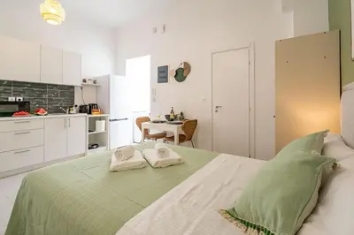 a bedroom with a bed with two towels on it at Piraeus Charm in Piraeus