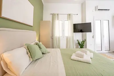 a bedroom with a bed with a teddy bear on it at Piraeus Charm in Piraeus