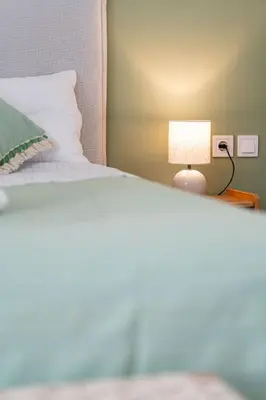 a bedroom with a bed with a lamp on it at Piraeus Charm in Piraeus