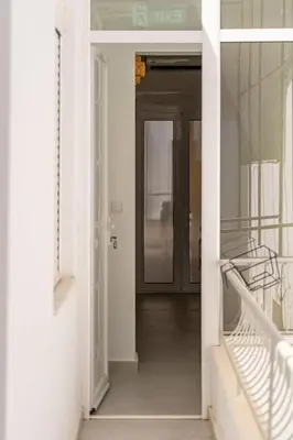 a hallway with a door leading into a room at Piraeus Charm in Piraeus