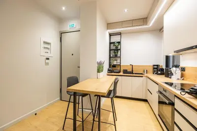 a kitchen with a wooden table and chairs at Rooms151 Smart Suite in the Heart of Athens 2nd floor-4S in Athens