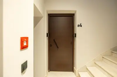 a hallway with a wooden door and stairs at Rooms151 Smart Suite in the Heart of Athens 2nd floor-4S in Athens