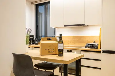 a bottle of wine sitting on a table in a kitchen at Rooms151 Smart Suite in the Heart of Athens 2nd floor-4S in Athens
