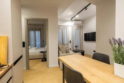 a kitchen and living room with a table and chairs at Rooms151 Smart Suite in the Heart of Athens 2nd floor-4S in Athens