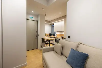 a living room with a couch and a kitchen at Rooms151 Smart Suite in the Heart of Athens 2nd floor-4S in Athens