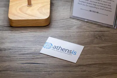 a sign sitting on top of a wooden table at Ermou Central Studios and Suites! in Athens