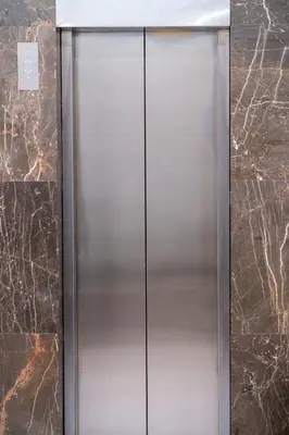 a stainless steel elevator in a marble wall at Ermou Central Studios and Suites! in Athens