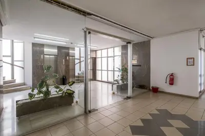 a large room with glass doors and potted plants at Ermou Central Studios and Suites! in Athens