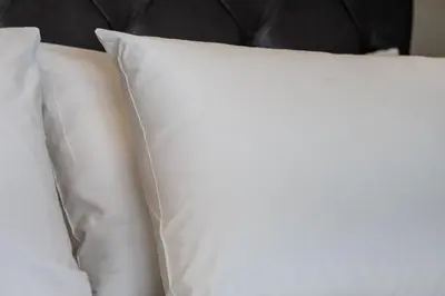 a stack of white pillows on a bed at Ermou Central Studios and Suites! in Athens