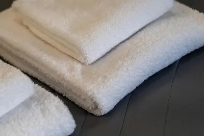 a pile of white towels sitting on a table at Ermou Central Studios and Suites! in Athens