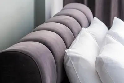 a row of white pillows on a bed at Ermou Central Studios and Suites! in Athens