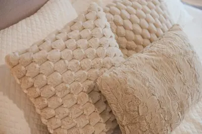 a close up of a bed with a white comforter at Modern Beach Retreat 2BR in Coastal Palaio Faliro in Athens